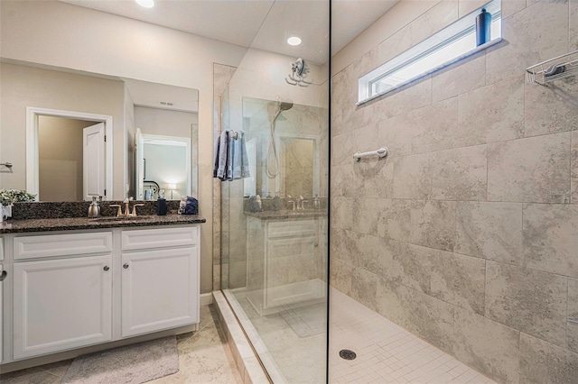 bathroom with vanity and a walk in shower