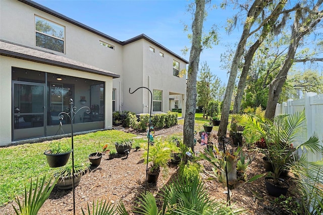 view of yard with fence and a sunroom