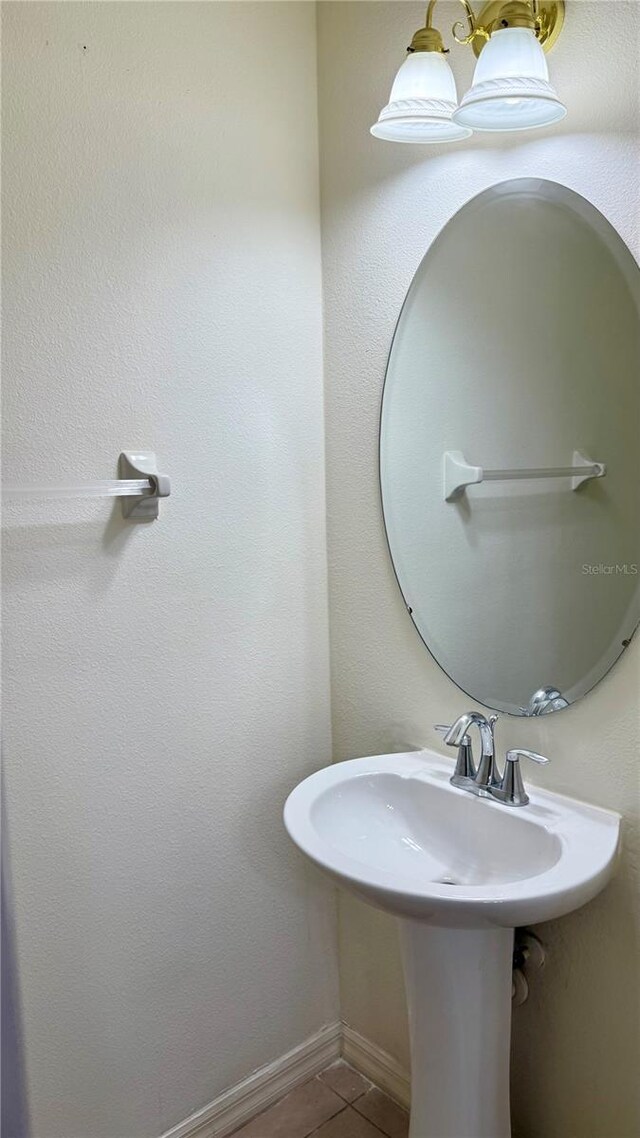 bathroom with tile patterned flooring and baseboards