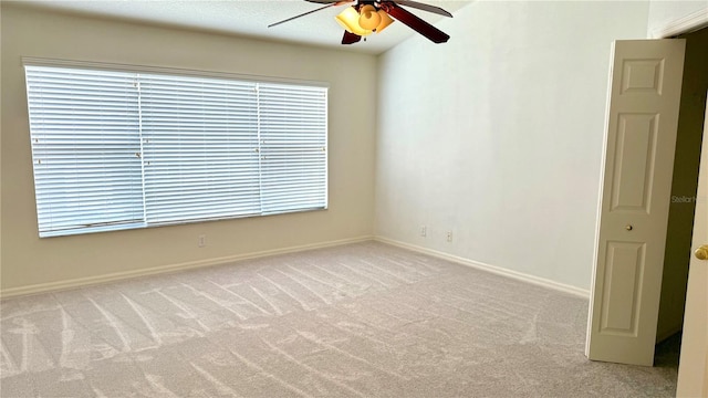 unfurnished room featuring a ceiling fan, baseboards, and carpet floors