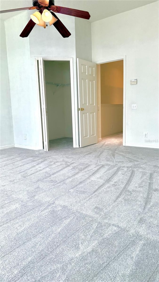 carpeted spare room with ceiling fan