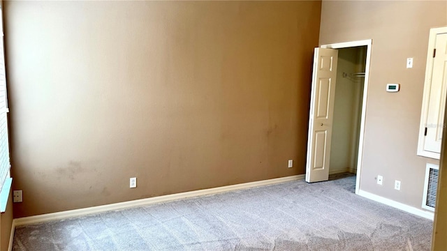 unfurnished bedroom featuring visible vents, baseboards, and carpet