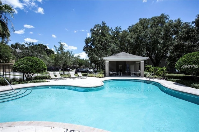 pool featuring a patio and fence