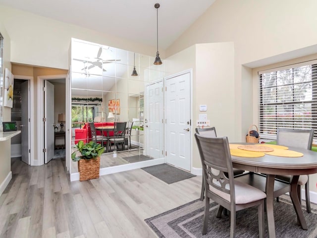 5100 Burchette Rd Unit 500, Tampa, FL 33647 - dining space featuring vaulted ceiling, wood finished floors, and baseboards