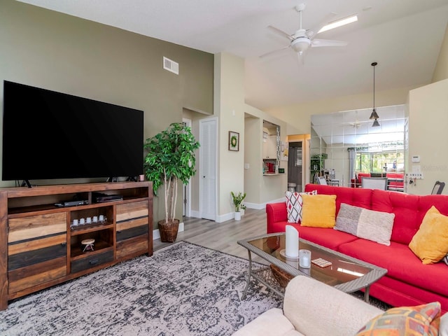5100 Burchette Rd Unit 500, Tampa, FL 33647 - living area with vaulted ceiling, baseboards, visible vents, a ceiling fan, and wood finished floors
