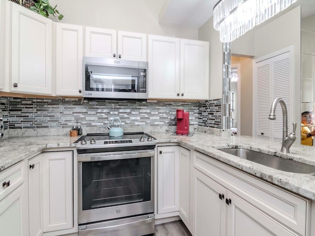 5100 Burchette Rd Unit 500, Tampa, FL 33647 - kitchen with white cabinets, appliances with stainless steel finishes, and a sink