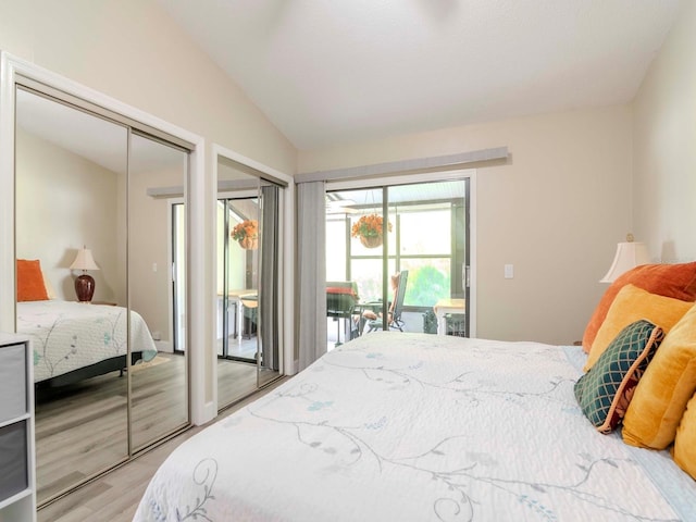 5100 Burchette Rd Unit 500, Tampa, FL 33647 - bedroom featuring light wood-type flooring, lofted ceiling, two closets, and access to exterior