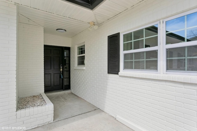 entrance to property with brick siding