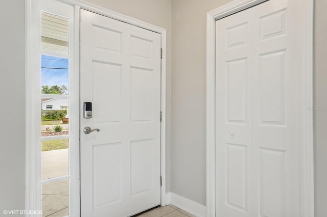 entrance foyer featuring light tile patterned floors and baseboards