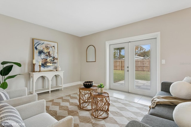 living room with light tile patterned floors, french doors, and baseboards