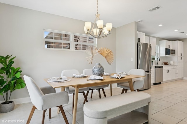 dining room featuring light tile patterned floors, visible vents, baseboards, and an inviting chandelier