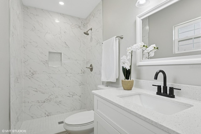 bathroom featuring recessed lighting, toilet, a shower stall, and vanity