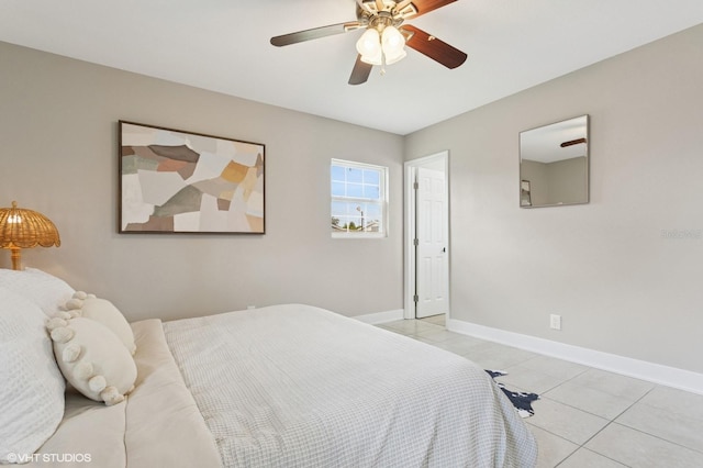 bedroom featuring light tile patterned floors, a ceiling fan, and baseboards