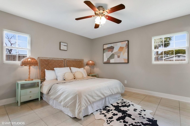 bedroom with light tile patterned floors, baseboards, and ceiling fan