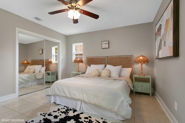 bedroom with visible vents, baseboards, a closet, and light tile patterned flooring