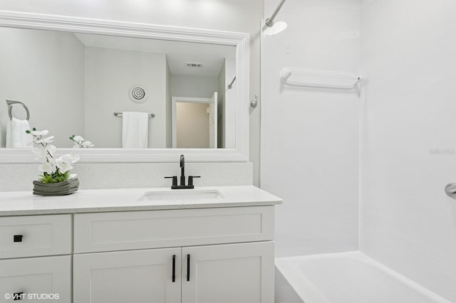 full bath featuring vanity, visible vents, and shower / bath combination