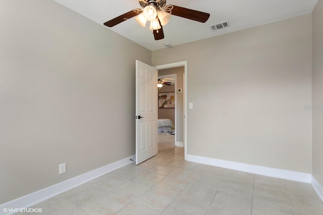 unfurnished room with baseboards, visible vents, and ceiling fan