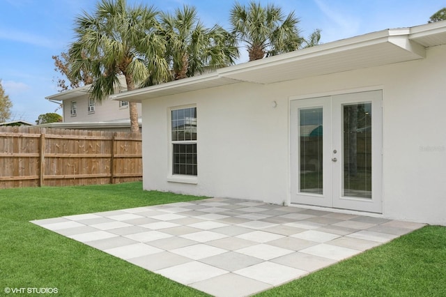 exterior space with a patio area, stucco siding, a lawn, and fence