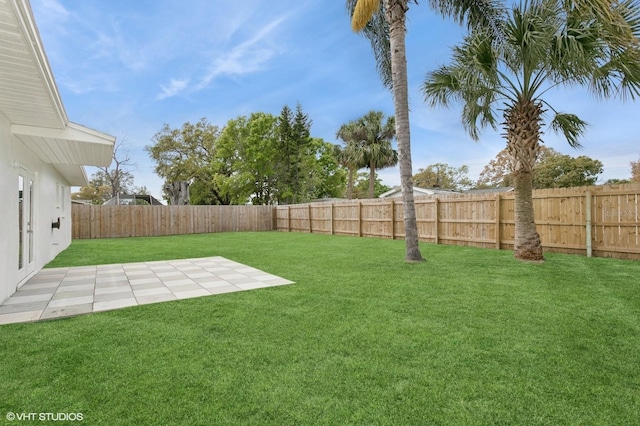 view of yard featuring a patio area and a fenced backyard