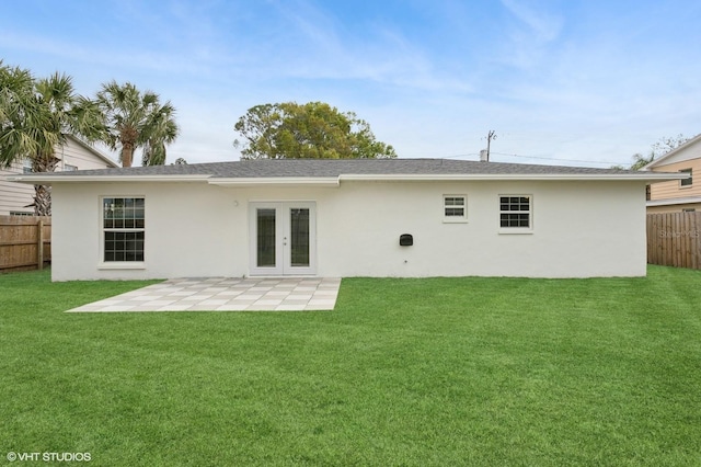 rear view of property featuring a patio, fence, a yard, stucco siding, and french doors