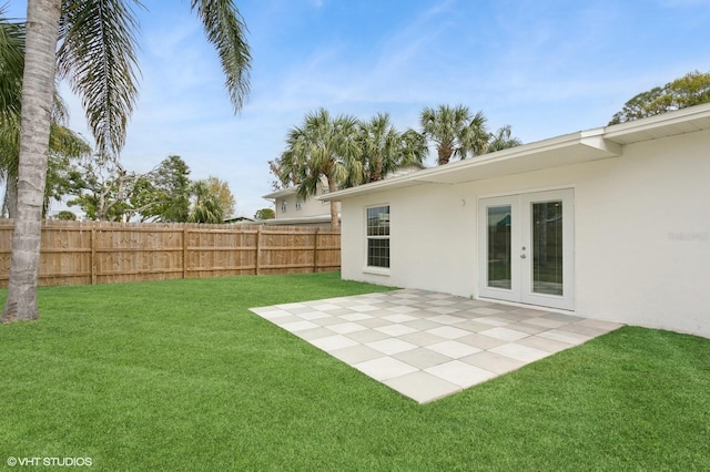 view of yard featuring french doors, a patio area, and fence