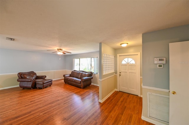 foyer with visible vents, baseboards, and wood finished floors