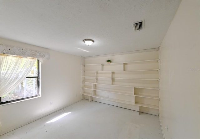 empty room featuring visible vents and concrete floors