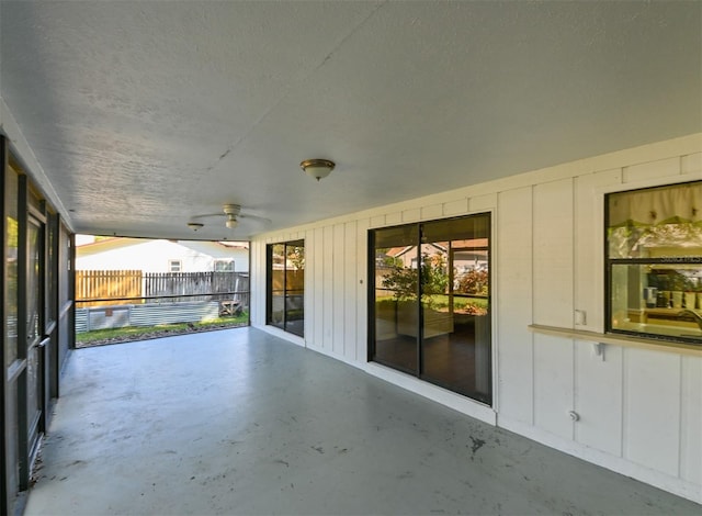 view of patio / terrace with ceiling fan and fence