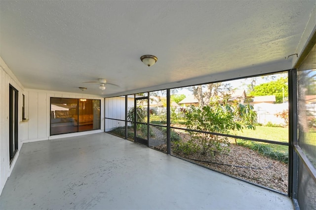 unfurnished sunroom with a ceiling fan