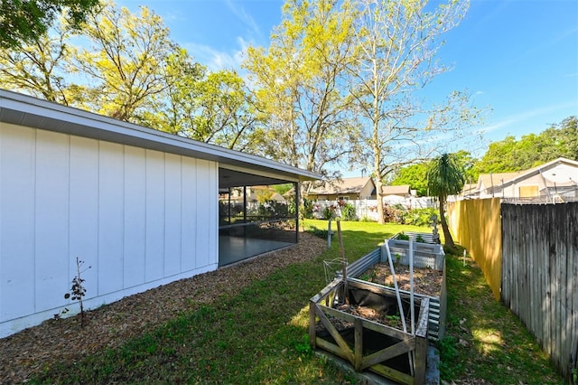 view of yard with a garden and a fenced backyard