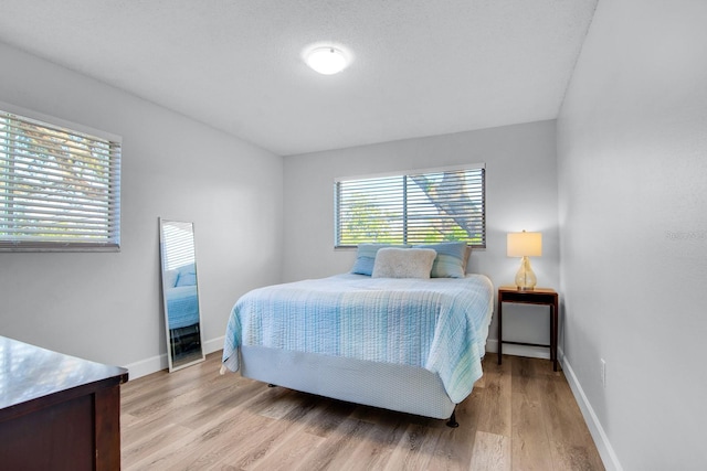 bedroom featuring light wood-type flooring and baseboards