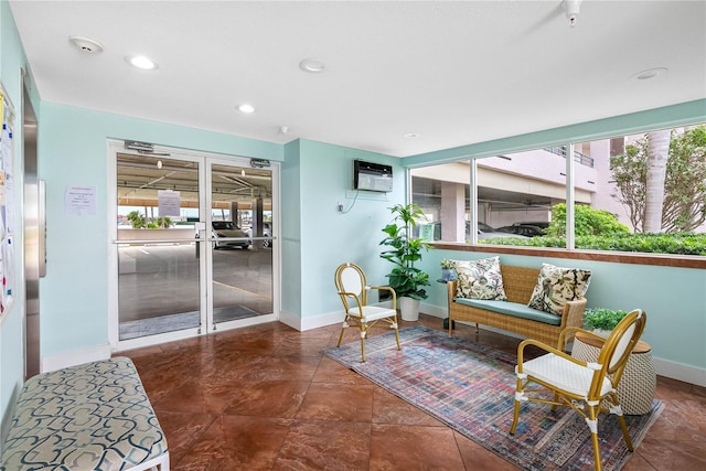 interior space with recessed lighting, baseboards, and a wall mounted AC