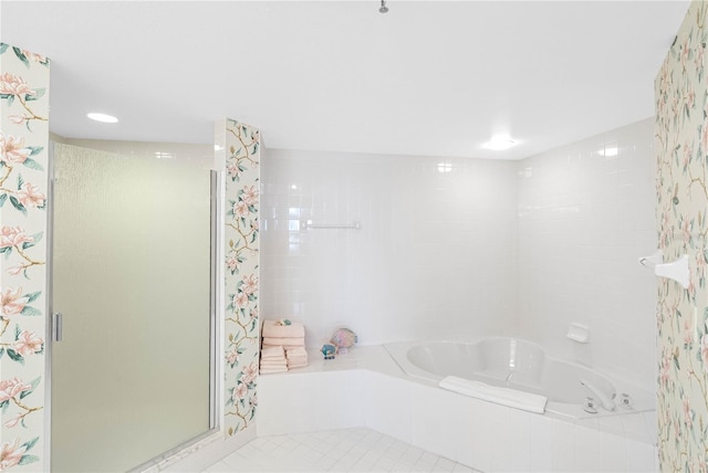 full bathroom featuring a garden tub and a shower stall