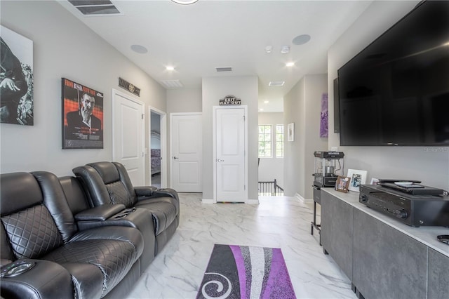 living room featuring visible vents, marble finish floor, and baseboards