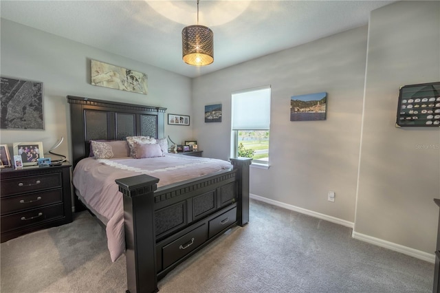 carpeted bedroom featuring baseboards