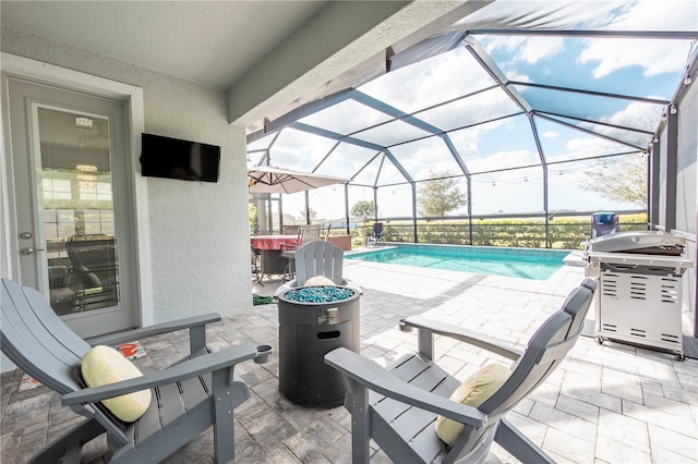 pool with glass enclosure and a patio area