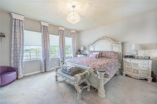 carpeted bedroom featuring baseboards and a notable chandelier
