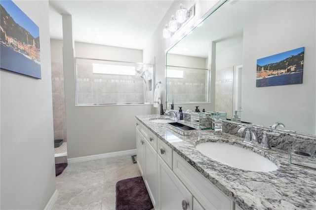 full bath featuring double vanity, a sink, baseboards, and walk in shower