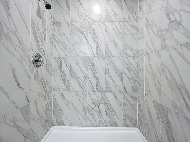 full bathroom with tiled shower