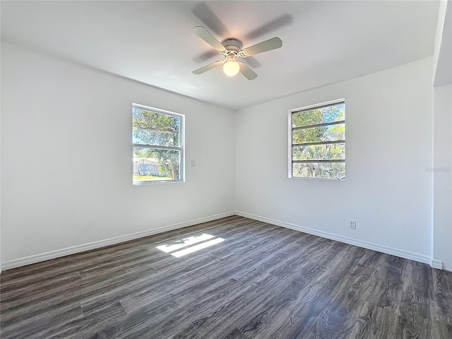 empty room with dark wood finished floors, baseboards, and ceiling fan