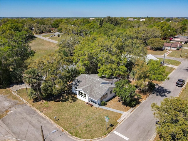 birds eye view of property featuring a wooded view