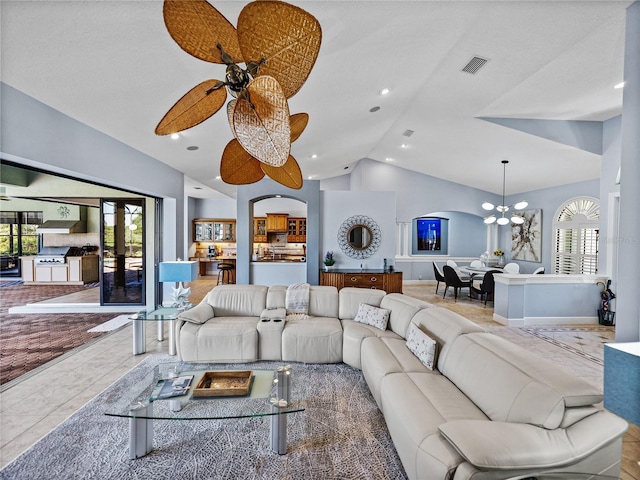 tiled living area featuring visible vents, recessed lighting, arched walkways, lofted ceiling, and ceiling fan with notable chandelier
