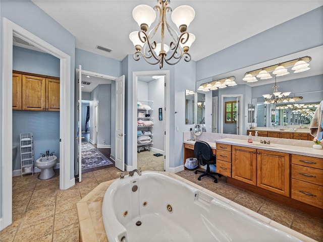 bathroom featuring vanity, an inviting chandelier, a tub with jets, a bidet, and visible vents
