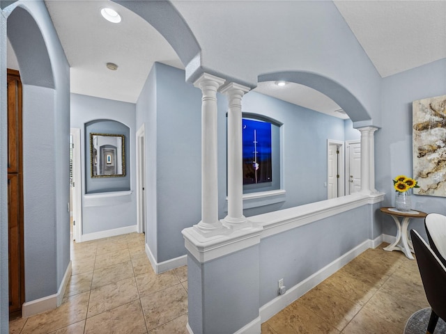 hallway with tile patterned floors and baseboards