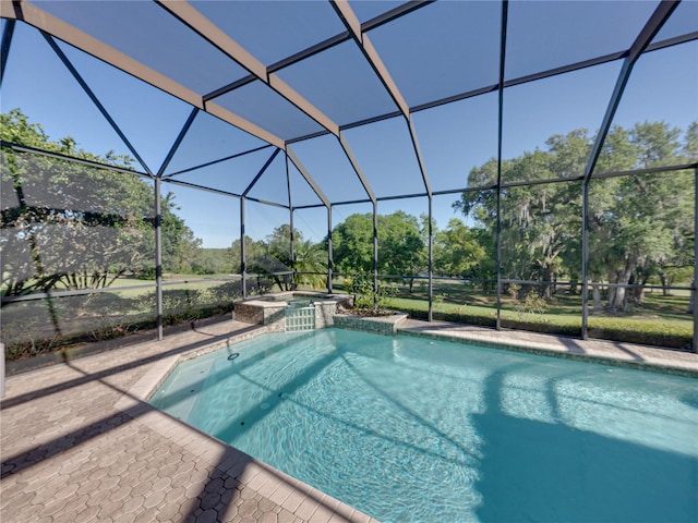 view of swimming pool with a pool with connected hot tub, a lanai, and a patio