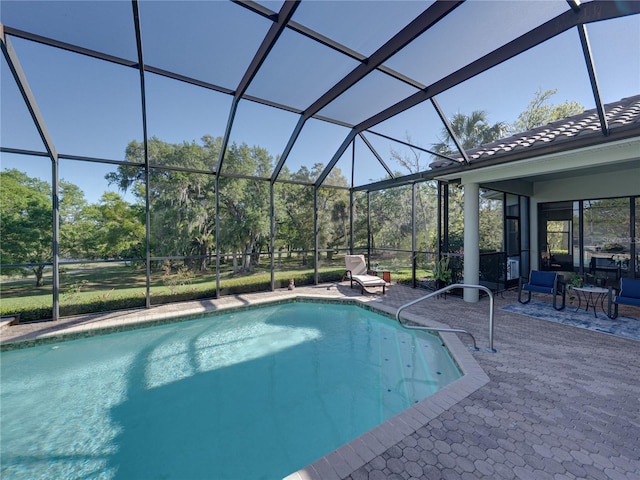 pool with a lanai and a patio area