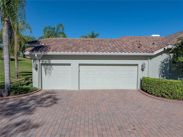 garage featuring decorative driveway