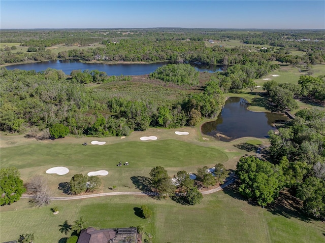 birds eye view of property featuring view of golf course, a water view, and a forest view