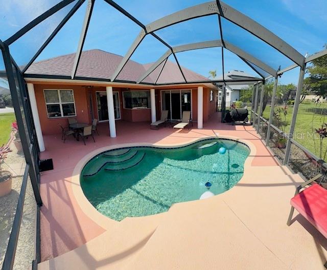 outdoor pool featuring a patio and a lanai