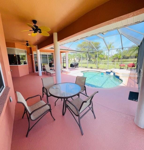 pool with a lanai, a ceiling fan, and a patio area